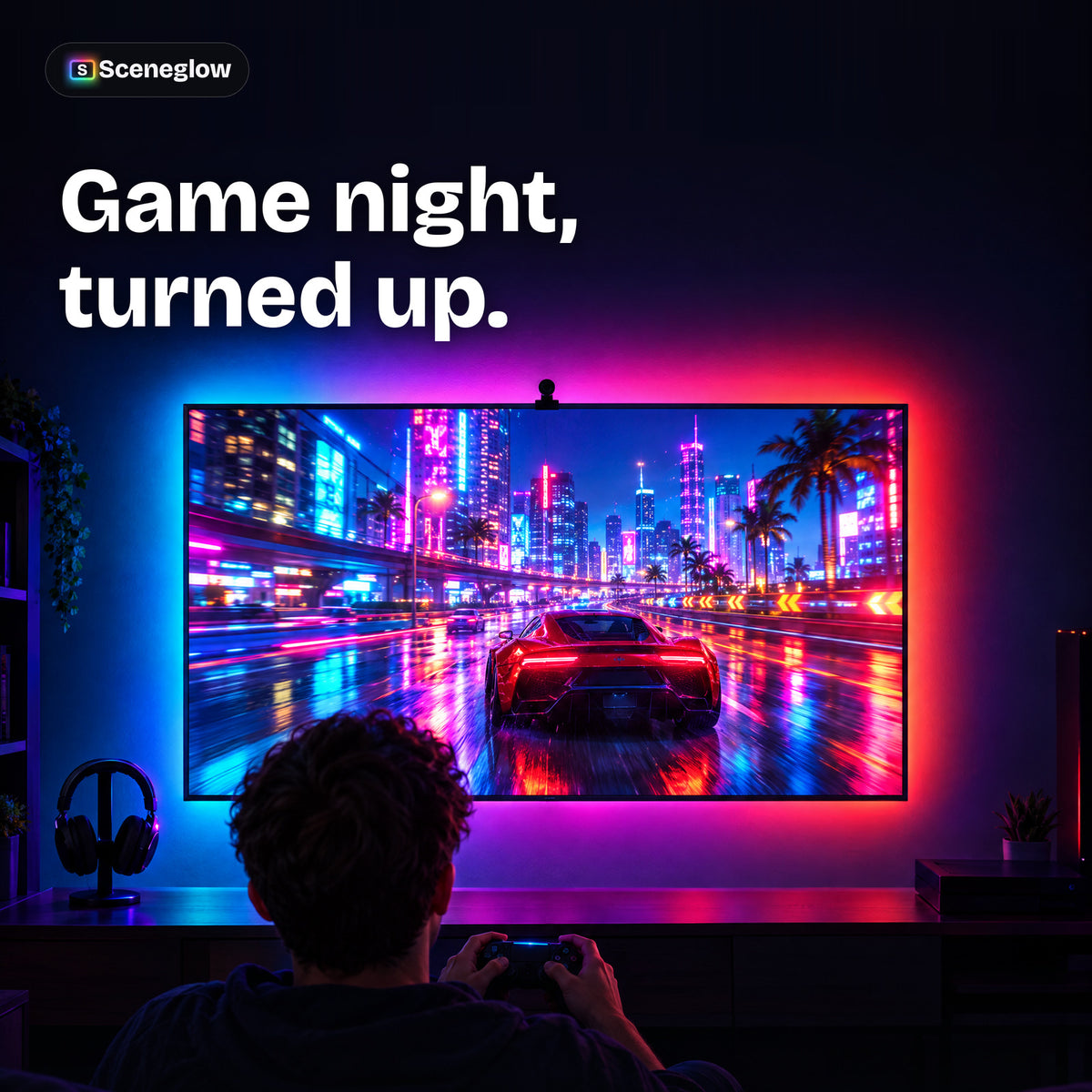 A gamer playing a racing game with the wall behind the TV glowing in matching colors